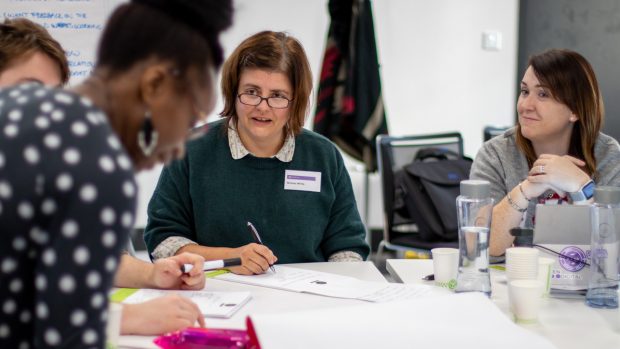 Three women hackers brainstorming about creating a skills matching application.