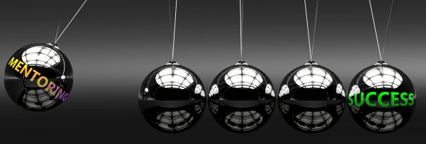 Mentoring success as a Newton cradle with metal balls giving energy and momentum to each other. Labels on balls are mentoring and success.